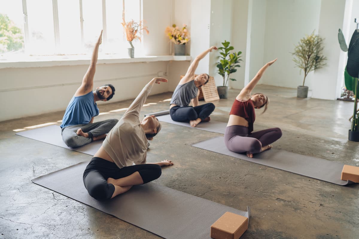 Yoga students observing and practicing during class