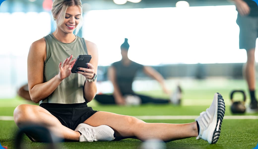 outique gym owner reviewing CRM dashboard with retention metrics