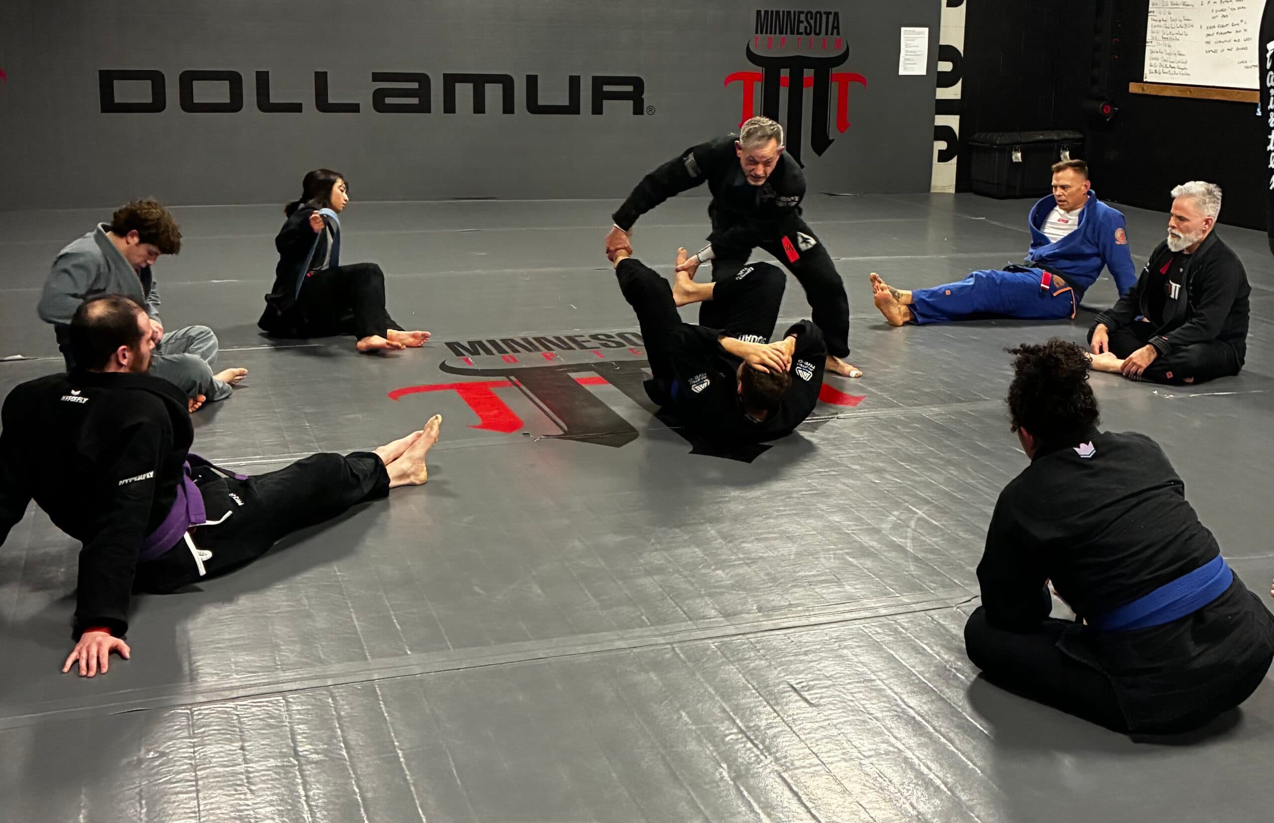 BJJ coach checking in members using gym management software at Minnesota Top Team