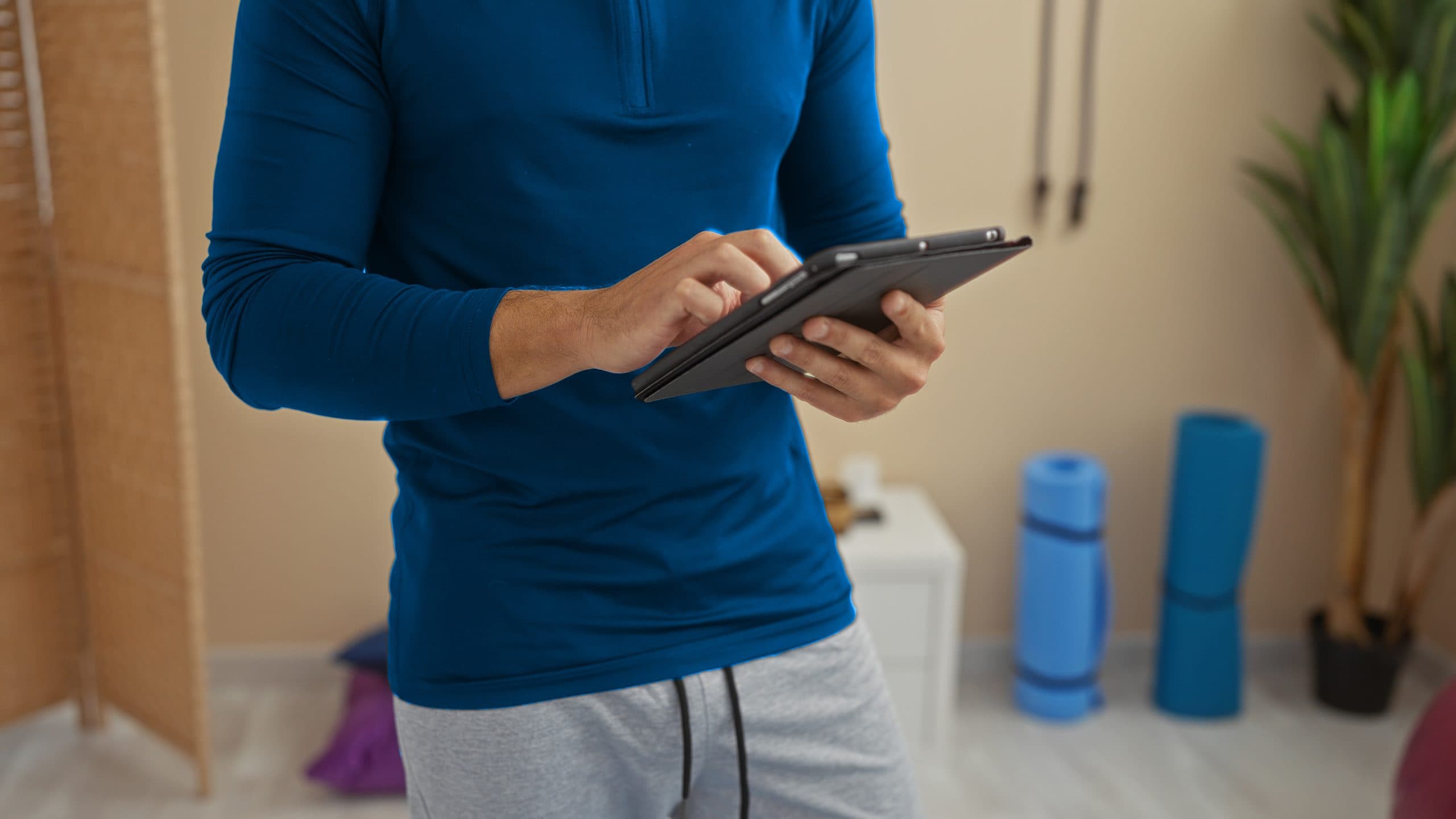 Martial arts school owner evaluating studio management software for scheduling, billing, belt tracking, and student management