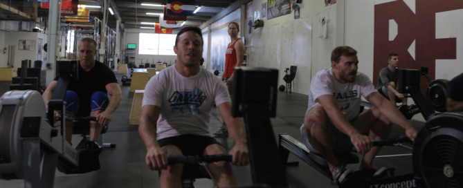 three athletes rowing