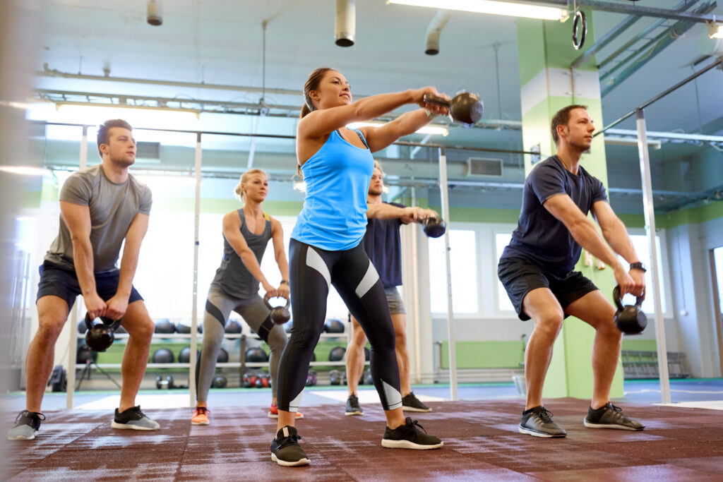 CrossFit athletes training together in an affiliate gym community