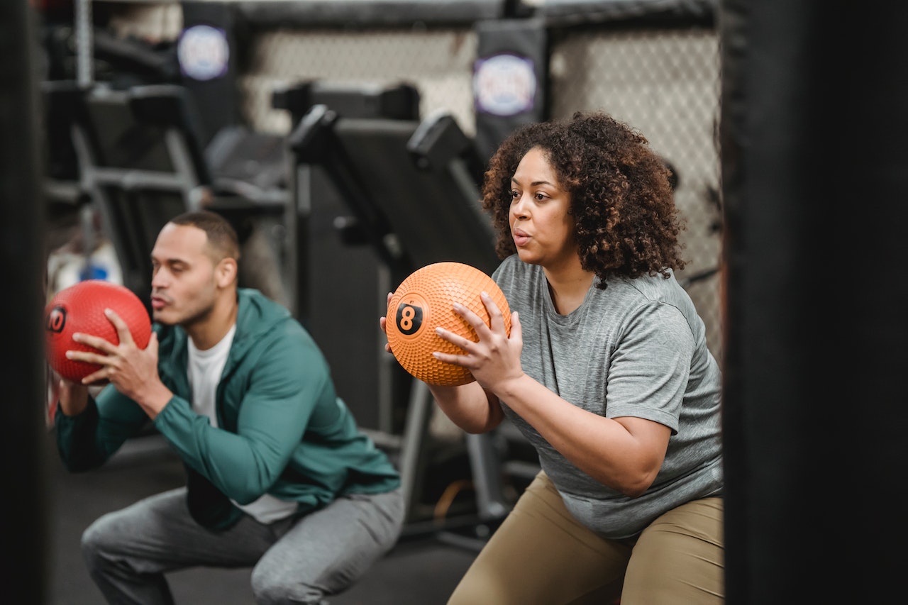 Two people working out in a gym