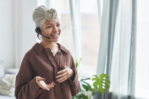 woman smiling while taking customer service call