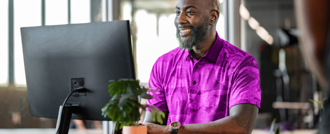 Gym owner using management software dashboard for scheduling and member tracking