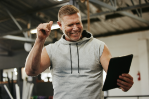 Gym owner connecting with members through tablet