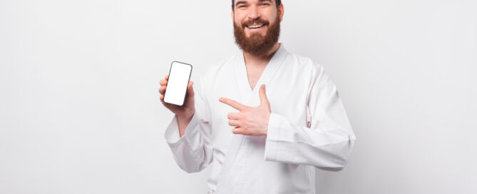 Martial arts instructor reviewing missed check-ins and student attendance gaps on a dashboard
