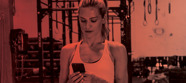 Martial arts instructor reviewing digital attendance dashboard on a tablet