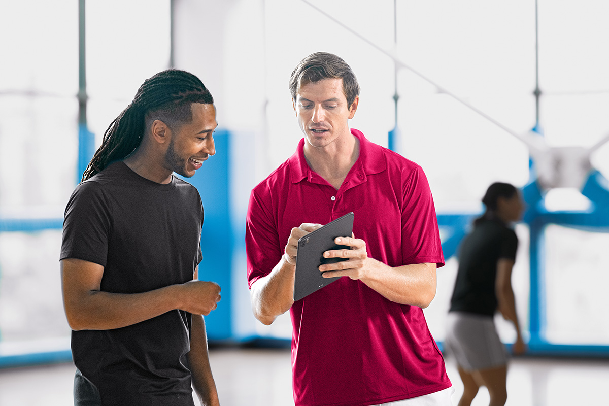 DAXKO-415-vitality Fitness business owner comparing gym management software features on a laptop
