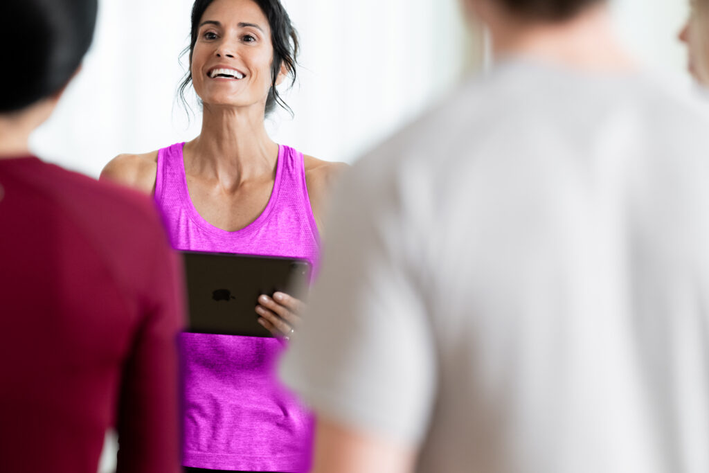 Fitness studio owner using management software dashboard for scheduling and analytics