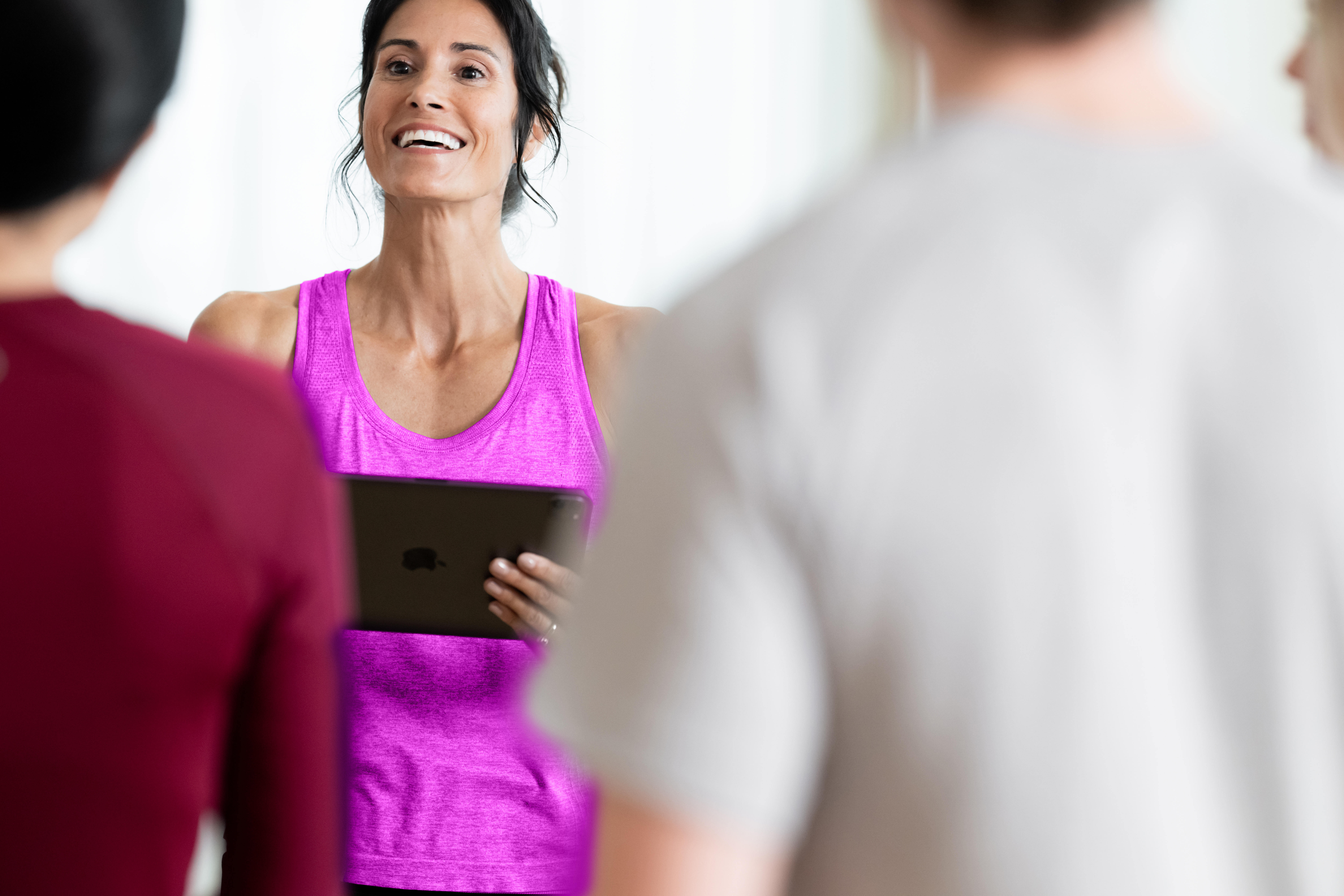 Fitness studio owner using management software dashboard for scheduling and analytics