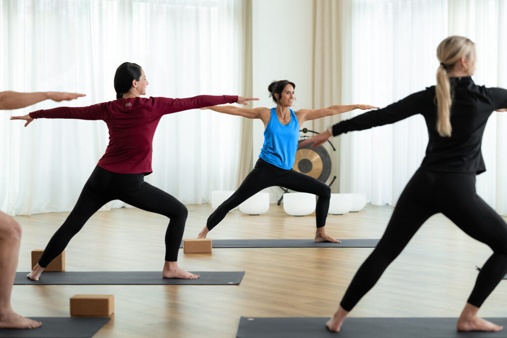 Studio owner managing in-person and virtual class schedule using Zen Planner’s hybrid gym software.