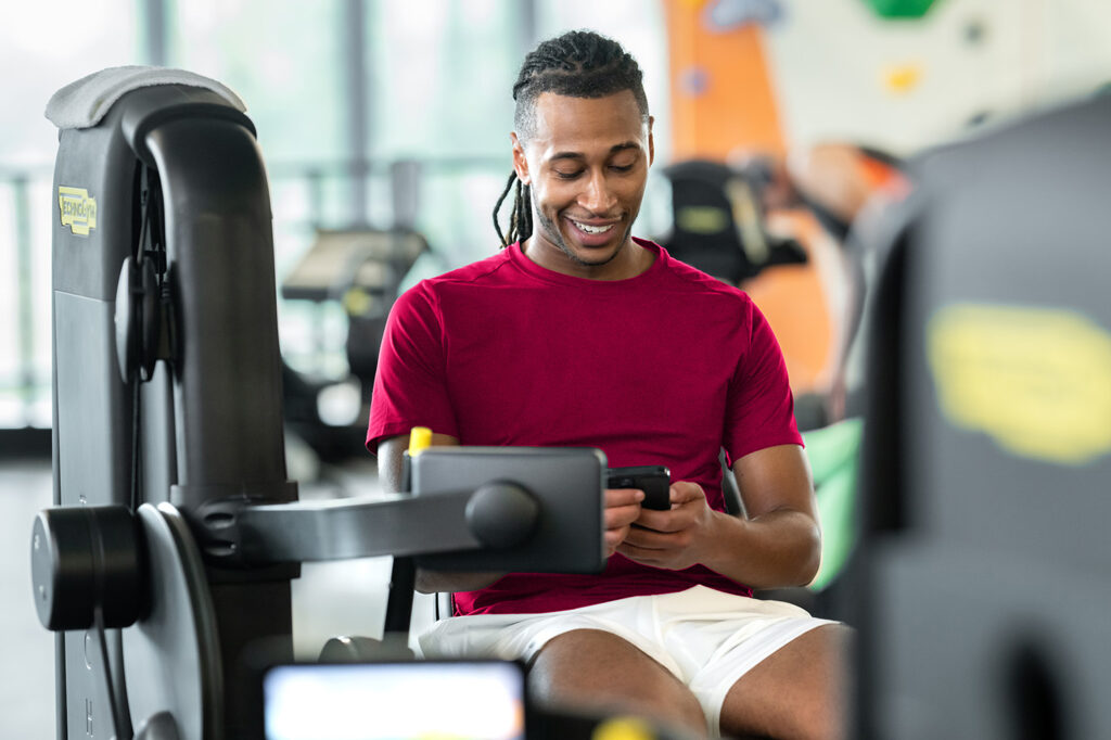 Hybrid fitness studio owner managing schedules and payments through Zen Planner’s all-in-one gym software.
