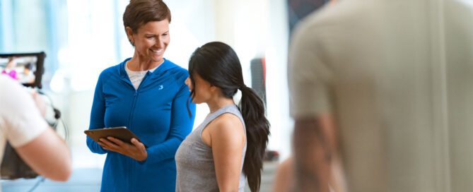 Gym owner reviewing Zen Planner billing software dashboard to track payments