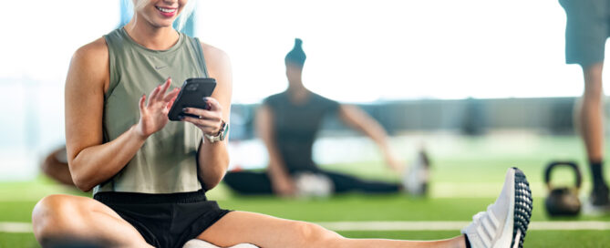 outique gym owner reviewing CRM dashboard with retention metrics