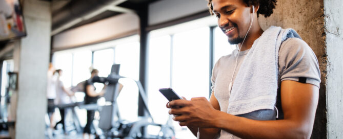 New gym owner evaluating fitness management software on a phone