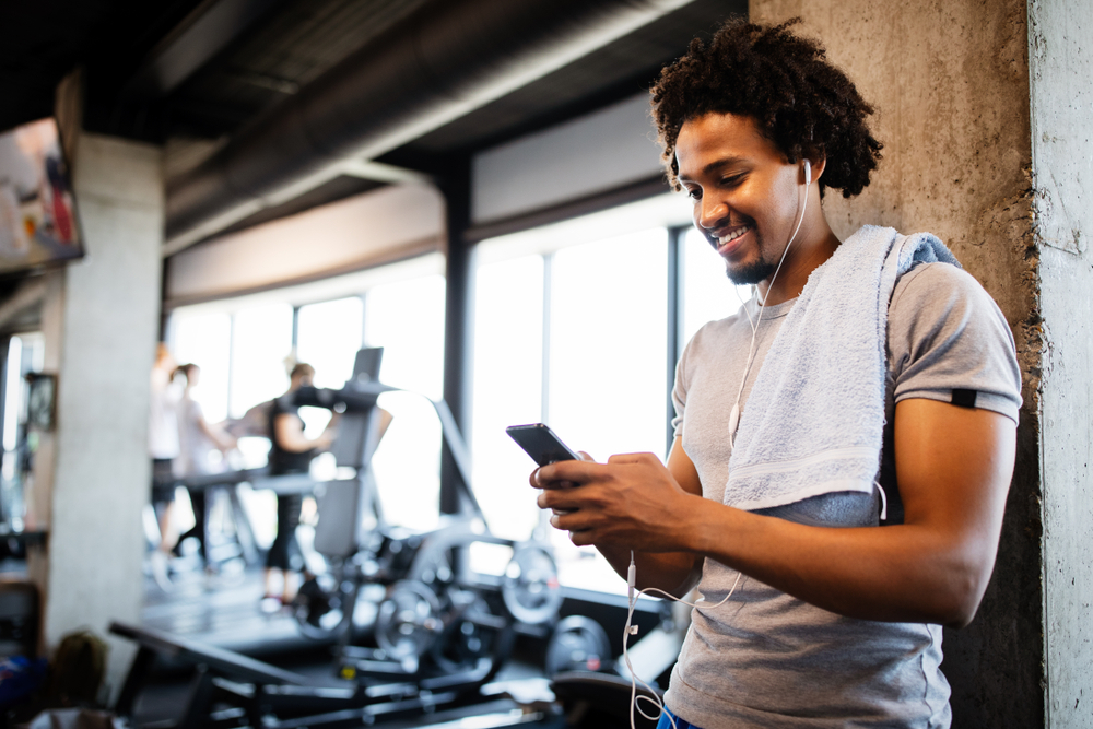 New gym owner evaluating fitness management software on a phone