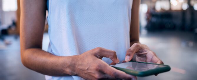 Fitness studio owner comparing software platforms on a tablet
