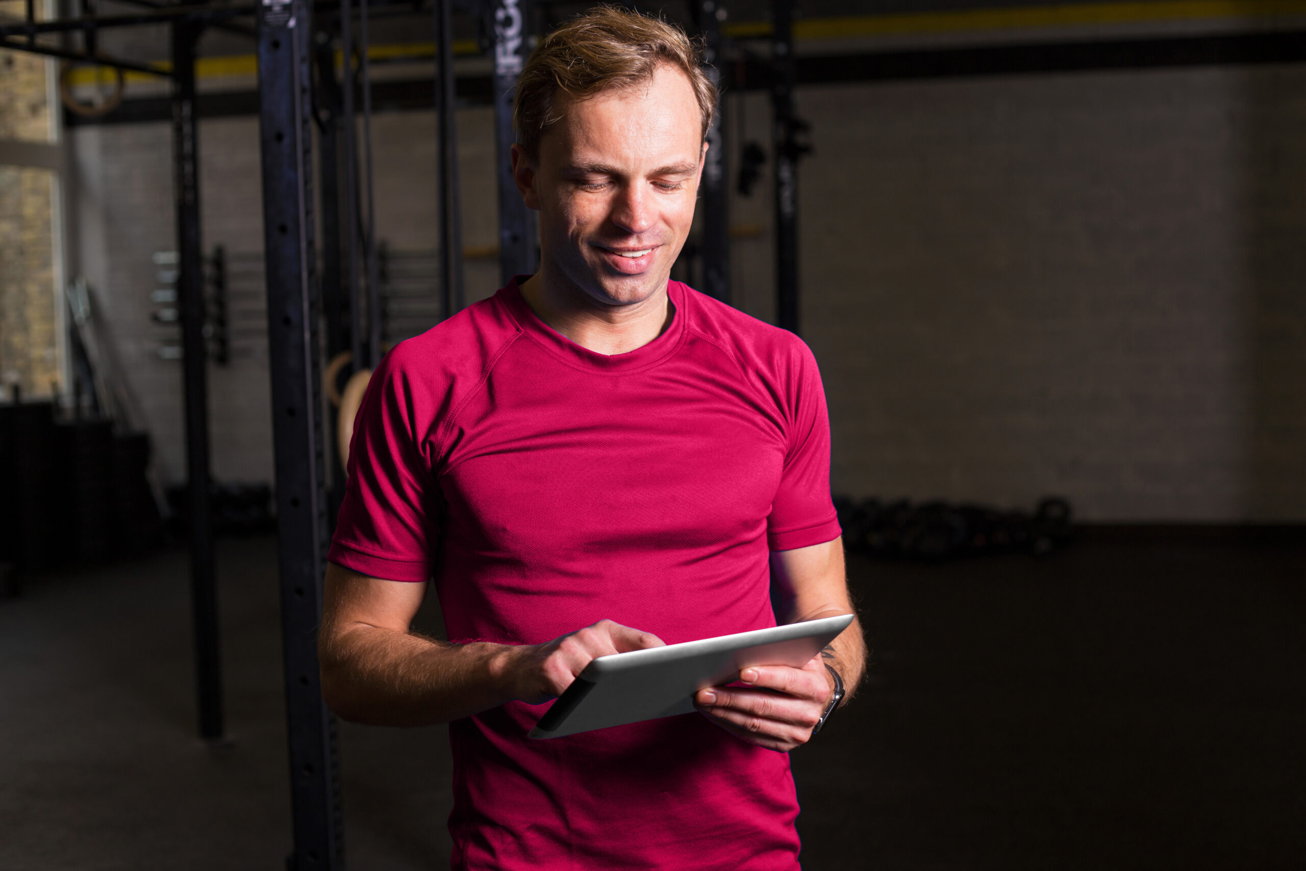 Fitness studio manager using class scheduling software to organize gym calendar