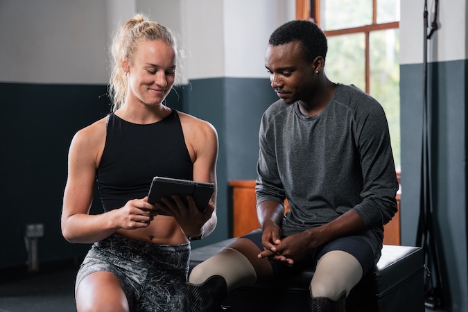 Physical_Therapist_With_Athlete_original_1612829 Gym owner reviewing digital marketing performance dashboard