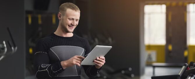 Gym owner using billing software on a tablet