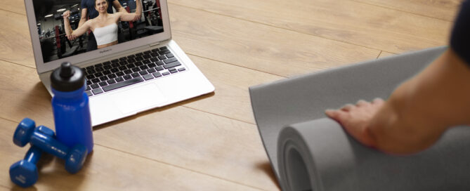 A Gym Trainer Managing Both Virtual and In-person Classes