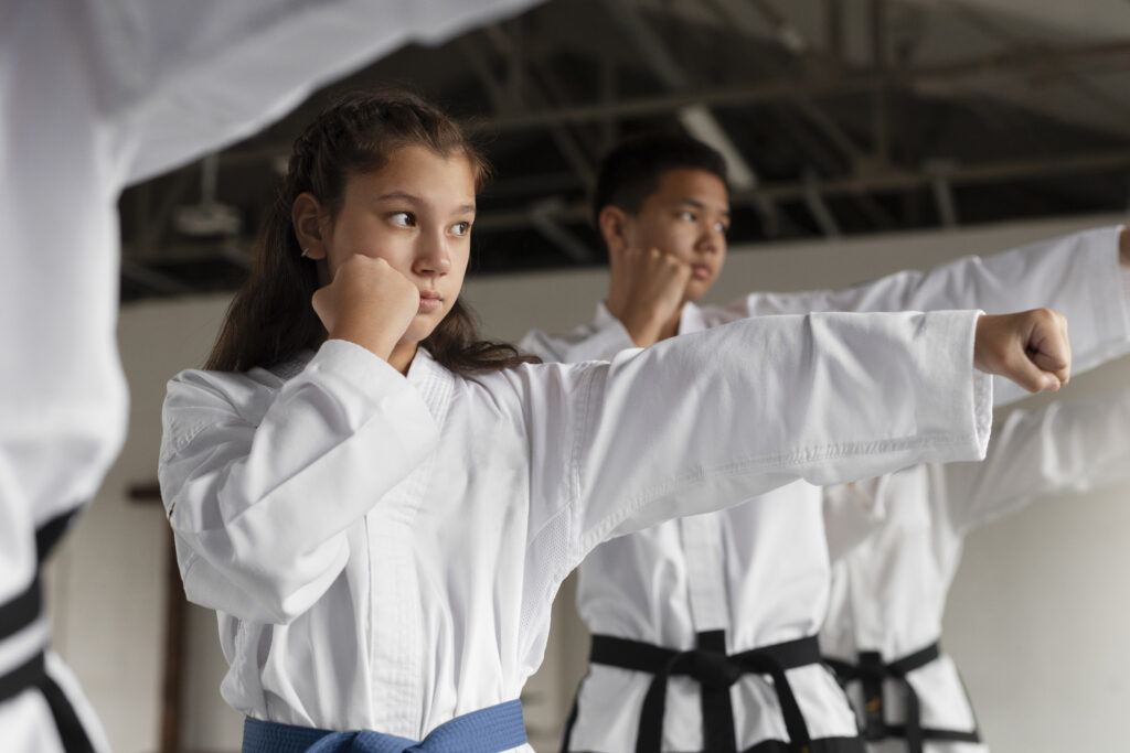 Martial arts students practicing punching technique in class.