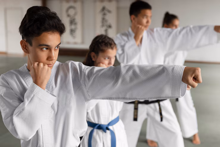 Group of Martial Arts Students Practicing Punching Techniques in a Dojo