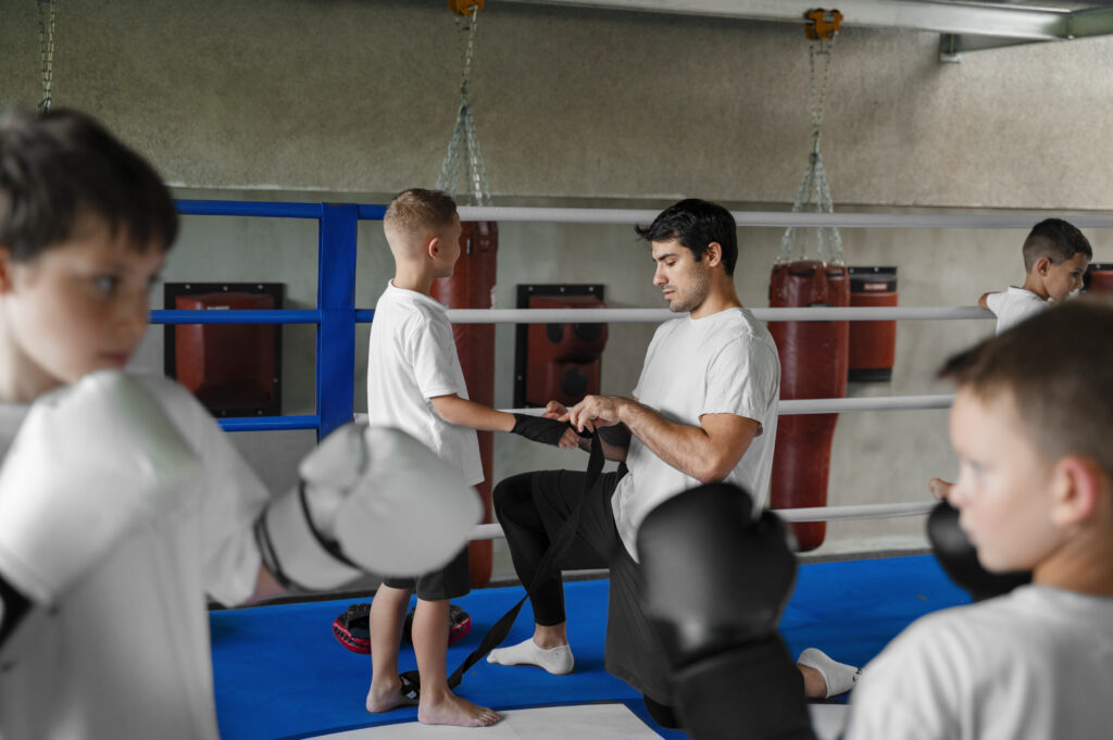 An Instructor Helping a Kid to be Ready for the Practice
