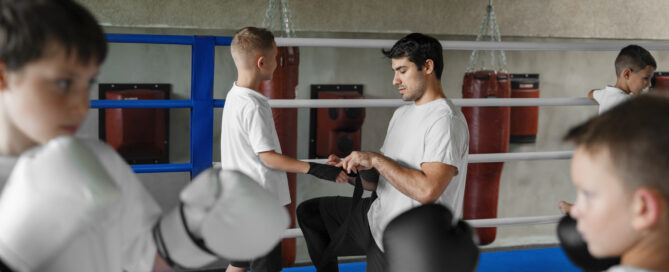 An Instructor Helping a Kid to be Ready for the Practice