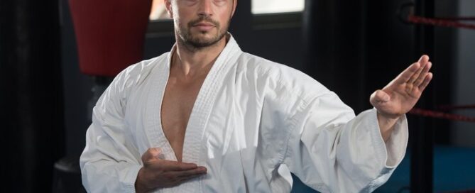 Martial Artist in a White Uniform Practicing a Kata Pose in a Dojo