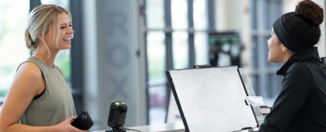 Fitness studio owner managing business with software tools.