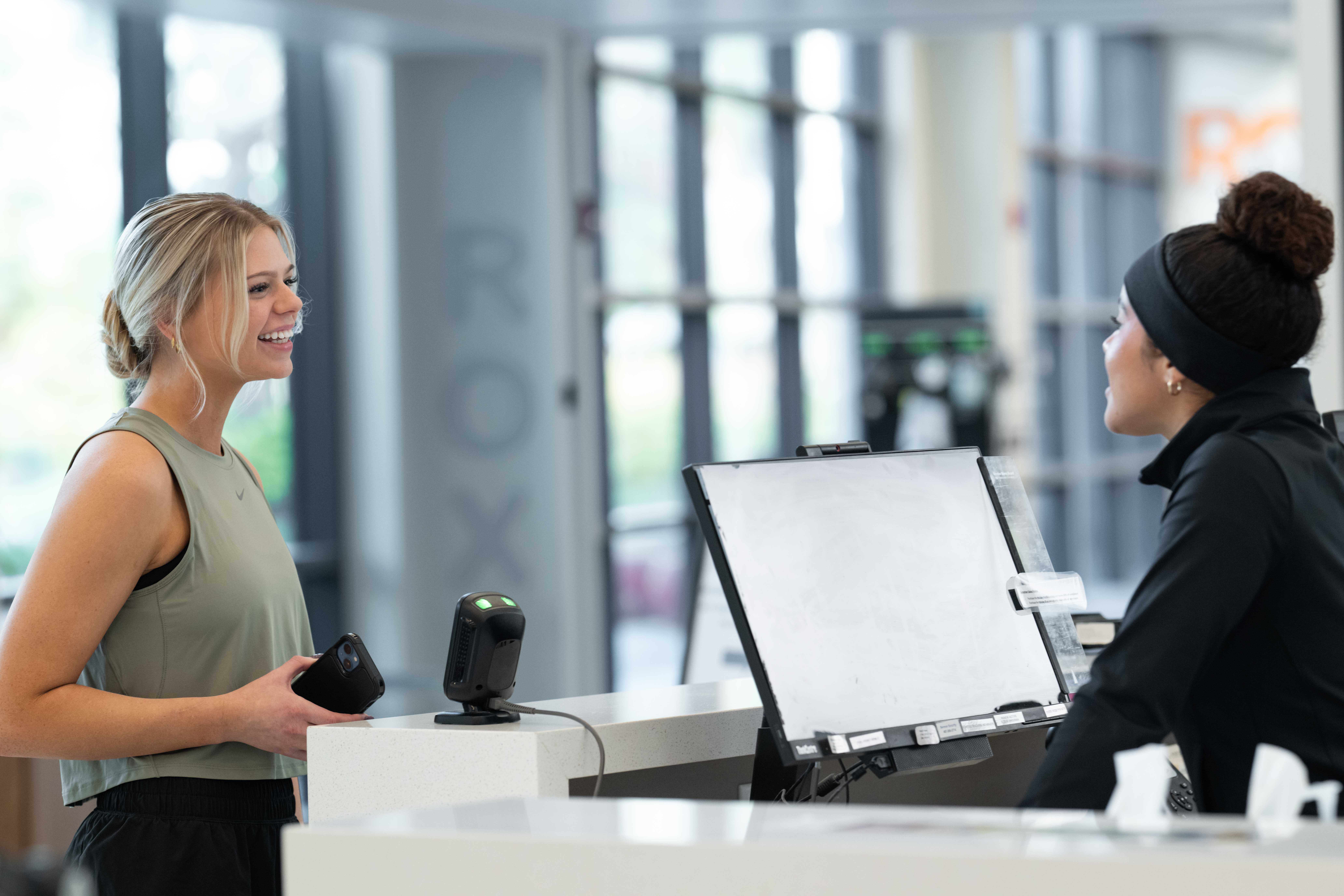 Fitness studio owner managing business with software tools.