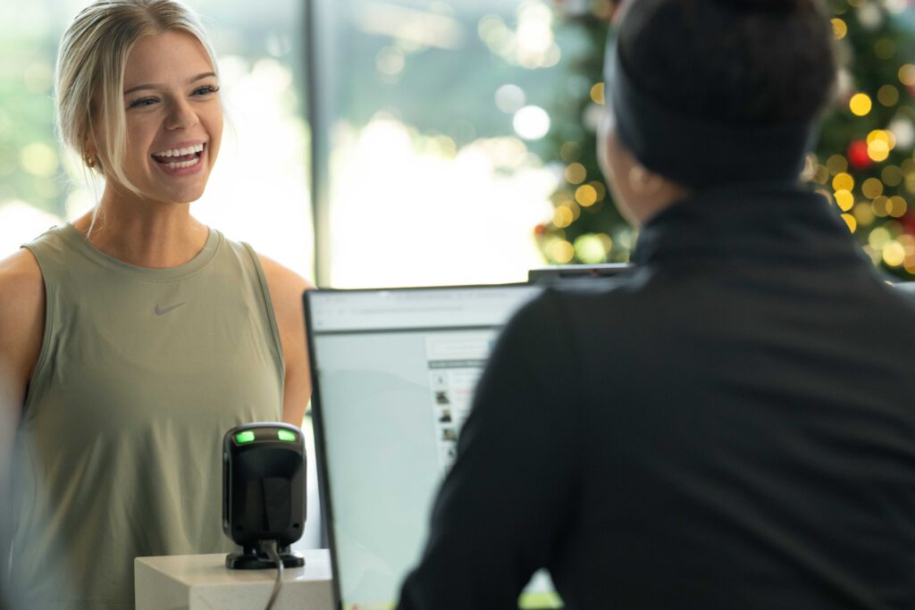 Gym owner using gym management software to enhance member experience and retention