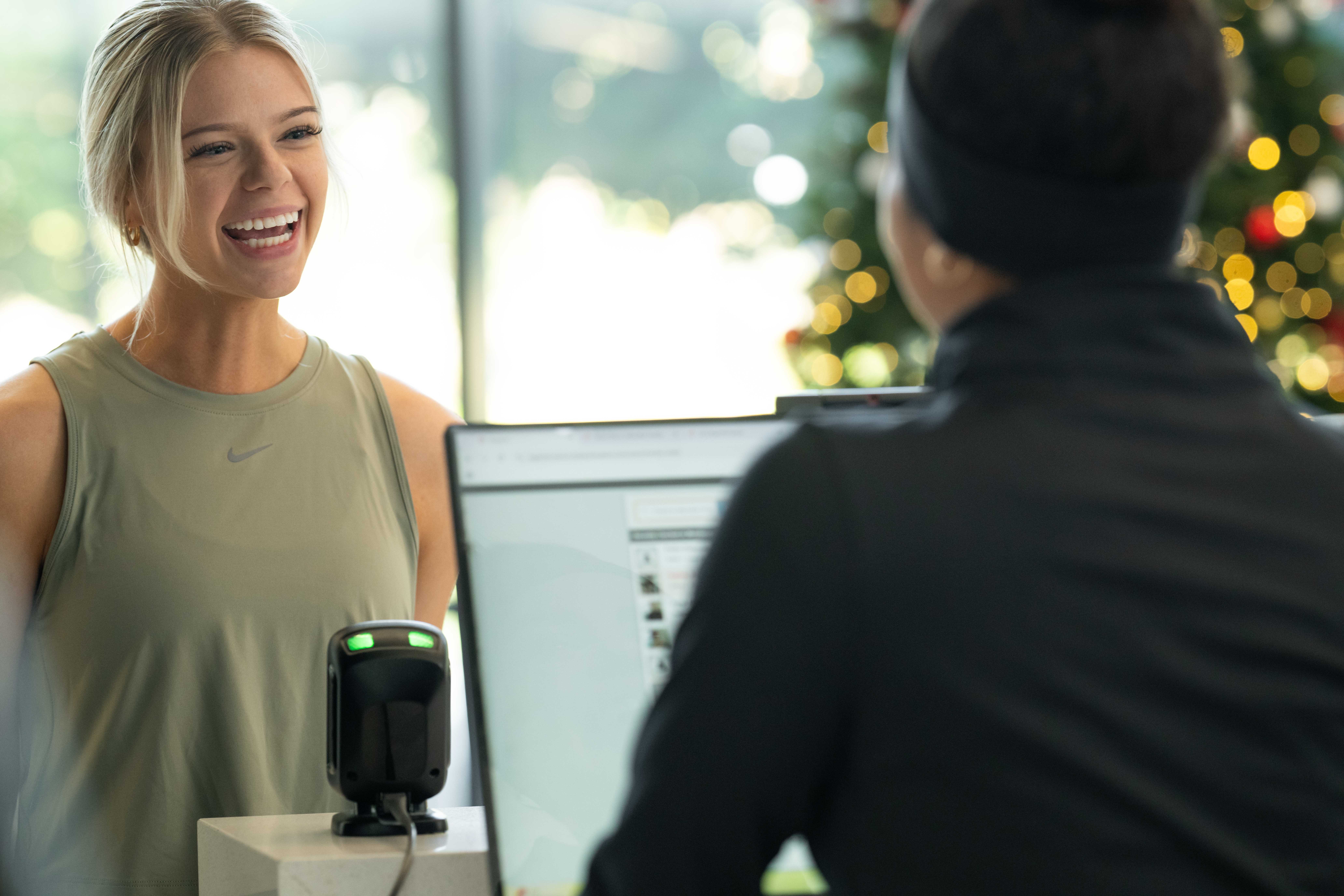 Gym owner using gym management software to enhance member experience and retention