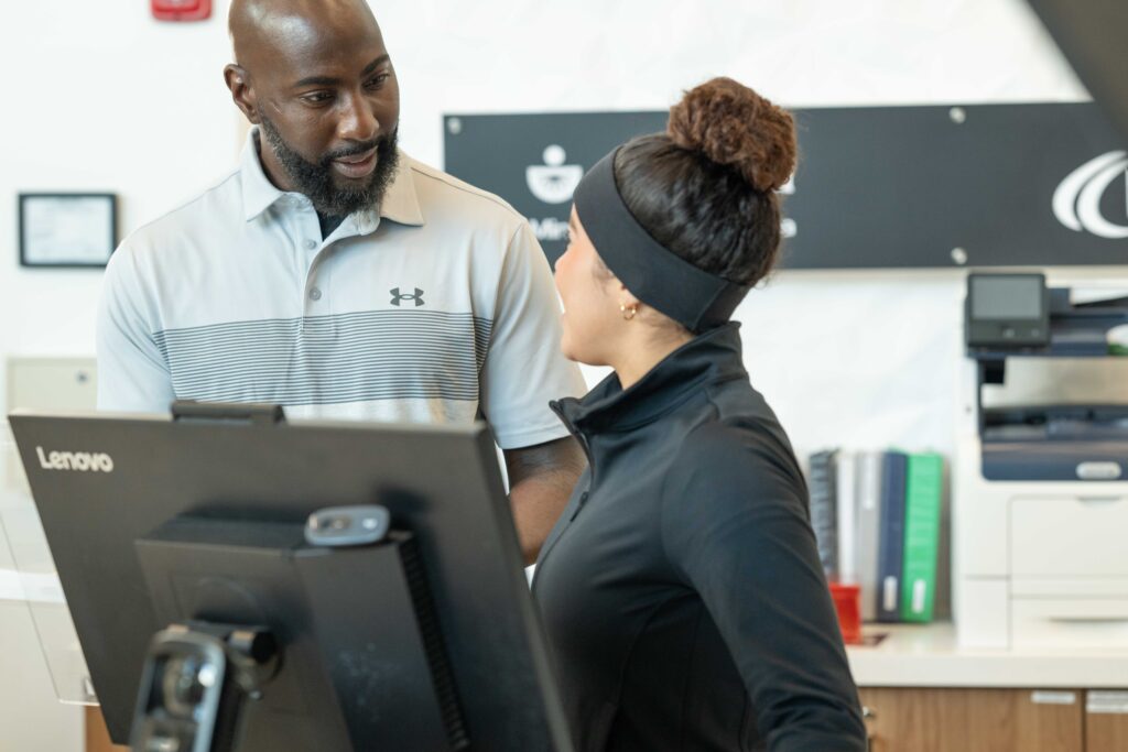 Gym staff using management software at the front desk
