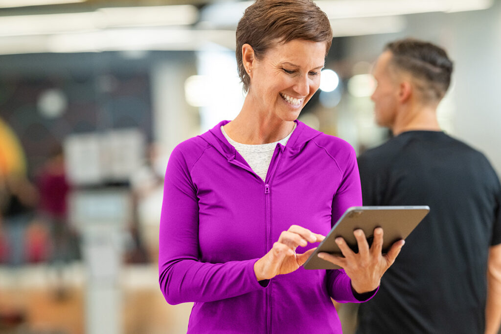 Fitness studio owner managing scheduling and memberships through fitness management software