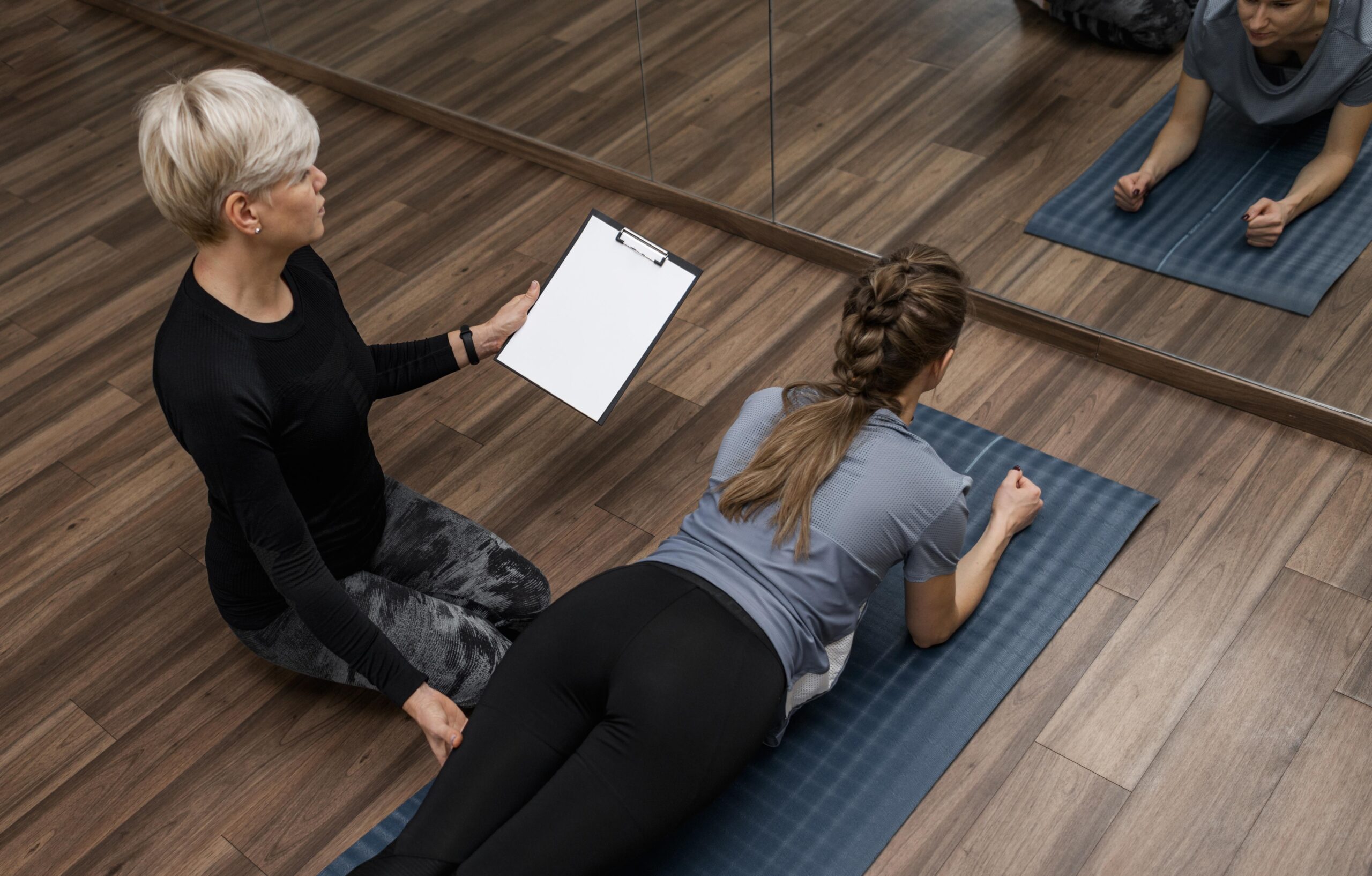 A Trainer Helping Her Student with Balancing