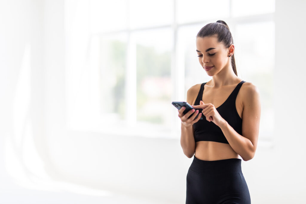 Women making gym payment using her phone
