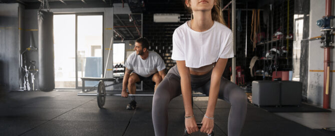 Focused gym workout with kettlebell and barbell training