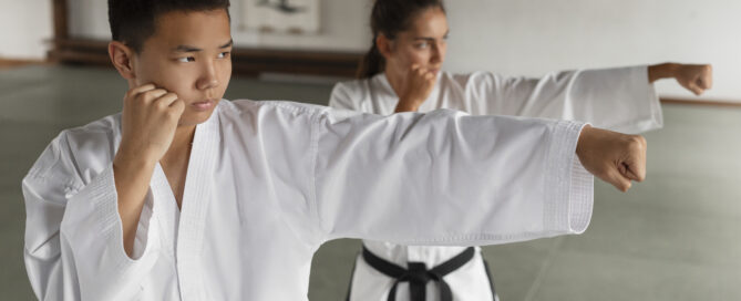 People practicing taekwondo in a martial arts school