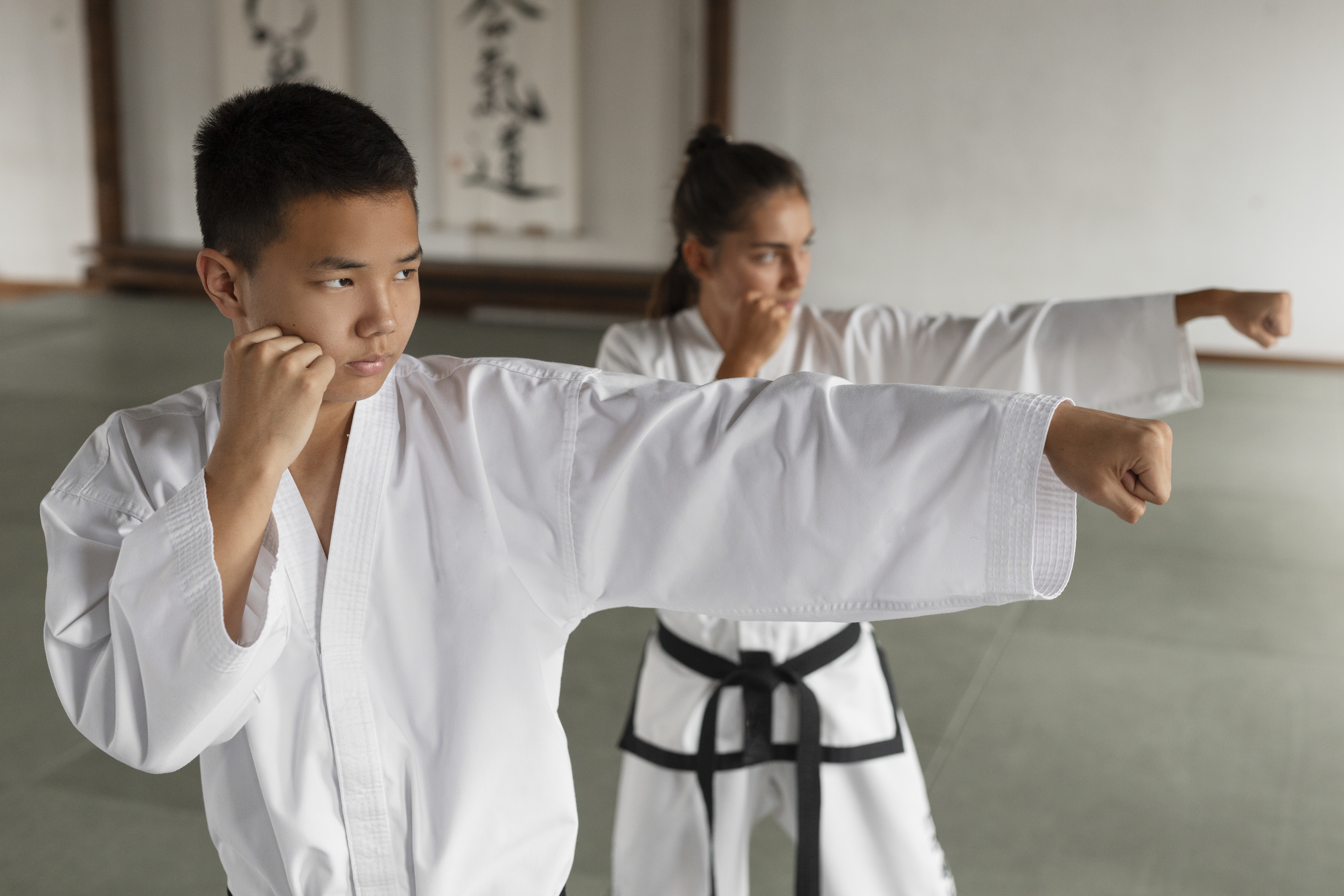 People practicing taekwondo in a martial arts school