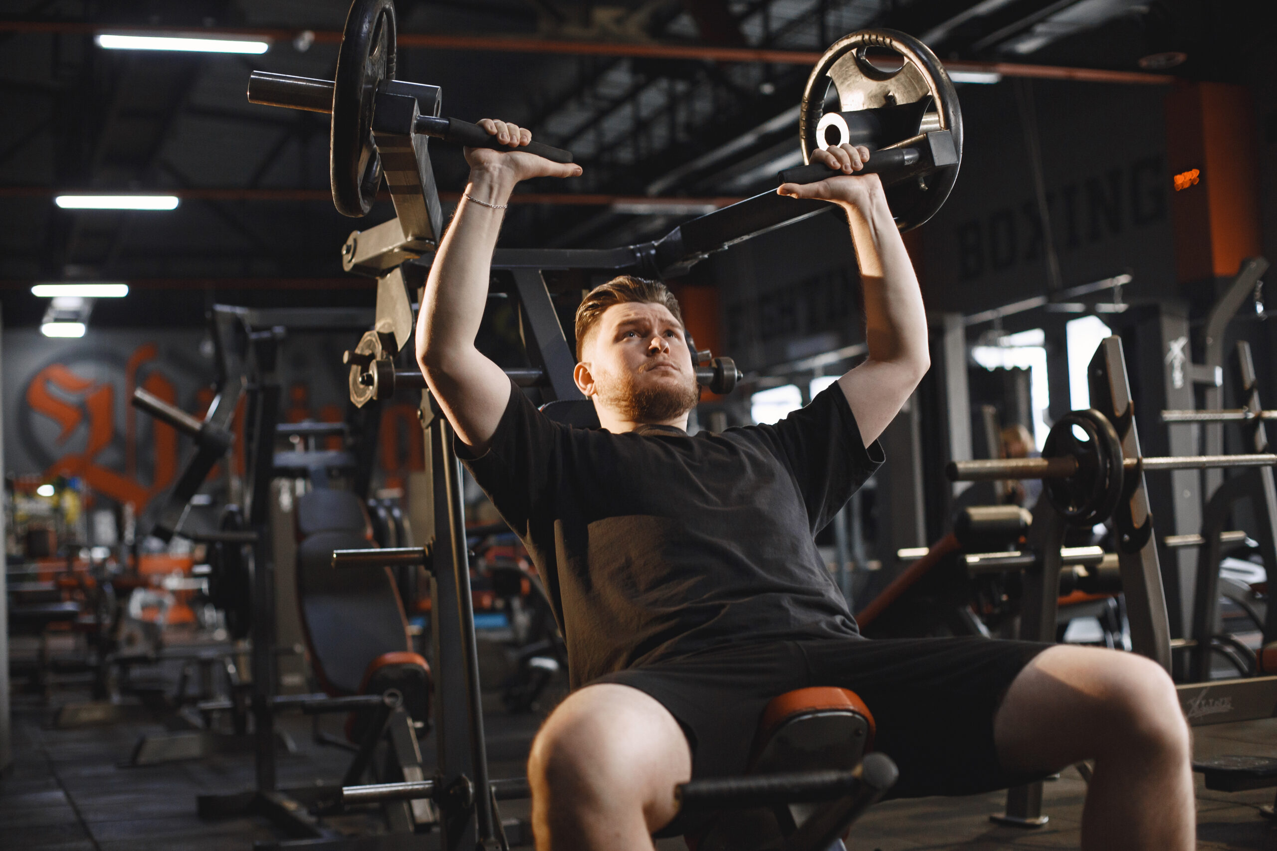 A handsome man is engaged in a gym A sportsman exercising in a gym