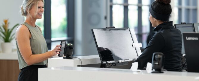 Martial arts instructor using CRM software to communicate with students