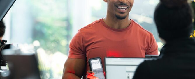 Instructor teaching martial arts students with CRM dashboard overlay
