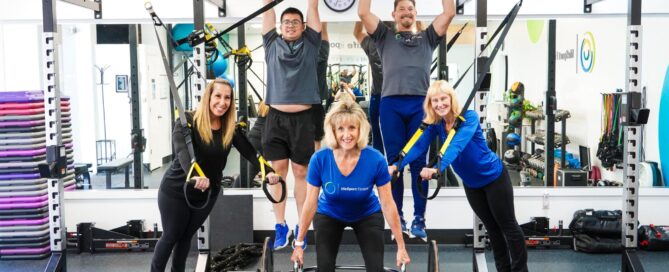 Becky coaches a semi-private session at LifeSport Fitness, guiding clients through personalized programs.