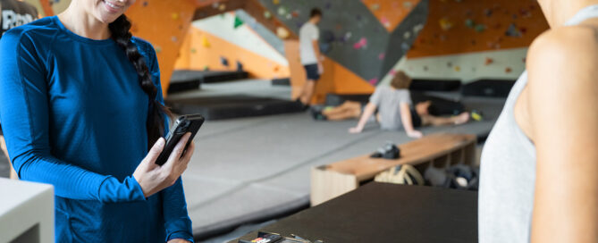 Gym owner reviewing payment dashboard with steady revenue metrics.