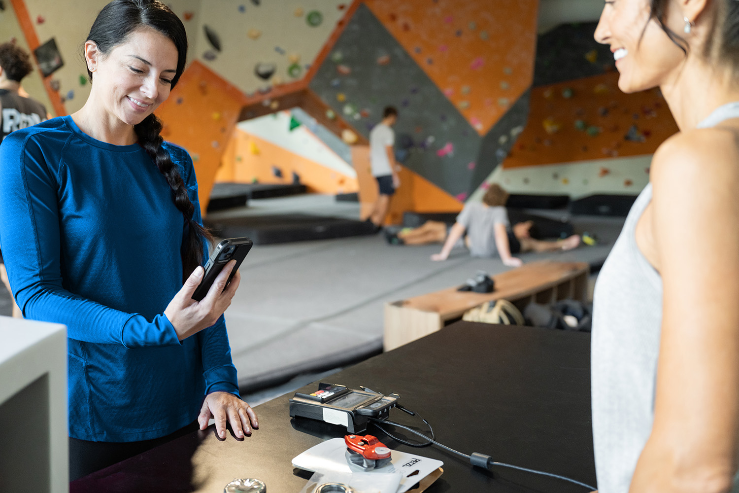Gym owner reviewing payment dashboard with steady revenue metrics.