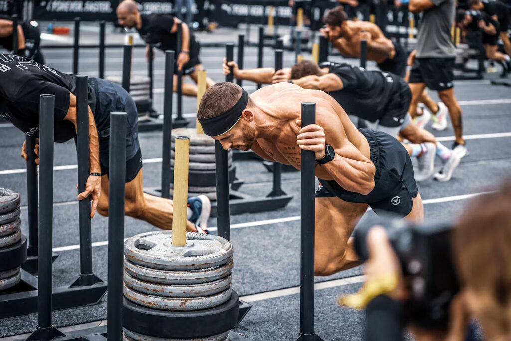 Athletes training together during a HYROX-style workout to improve community and retention