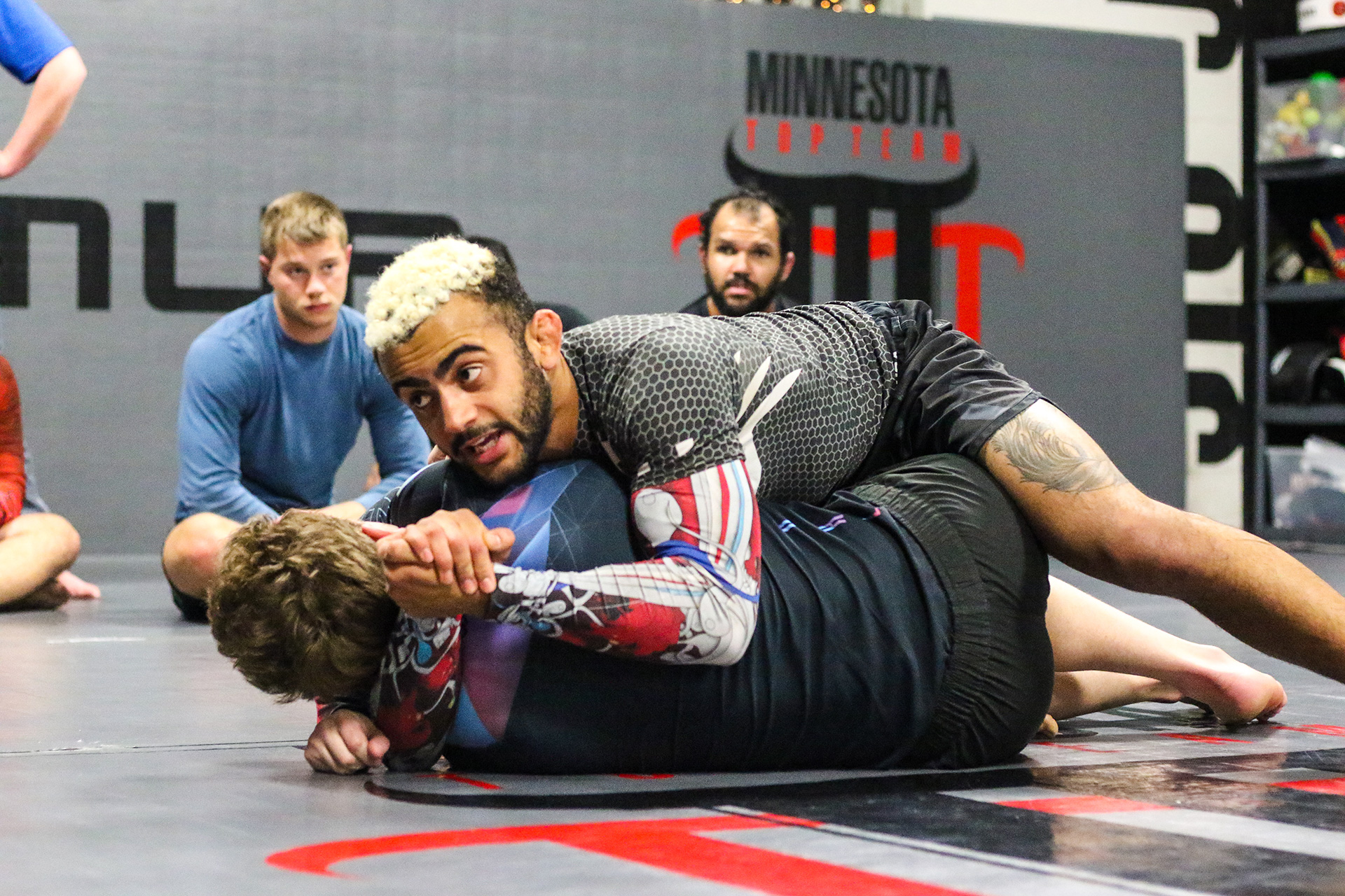 BJJ coach checking in members using gym management software at Minnesota Top Team